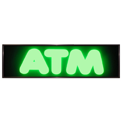 Glowing green ATM sign on a black background.